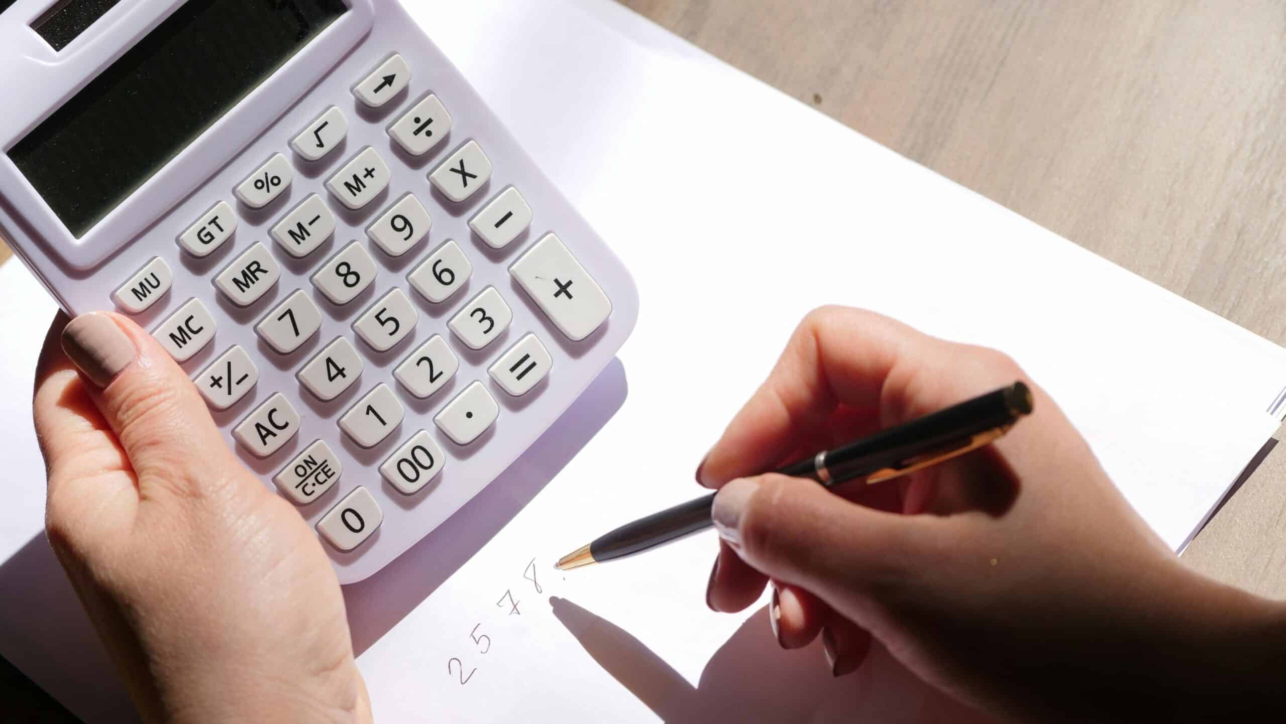 Person using calculator representing how to calculate overtime pay in Ontario